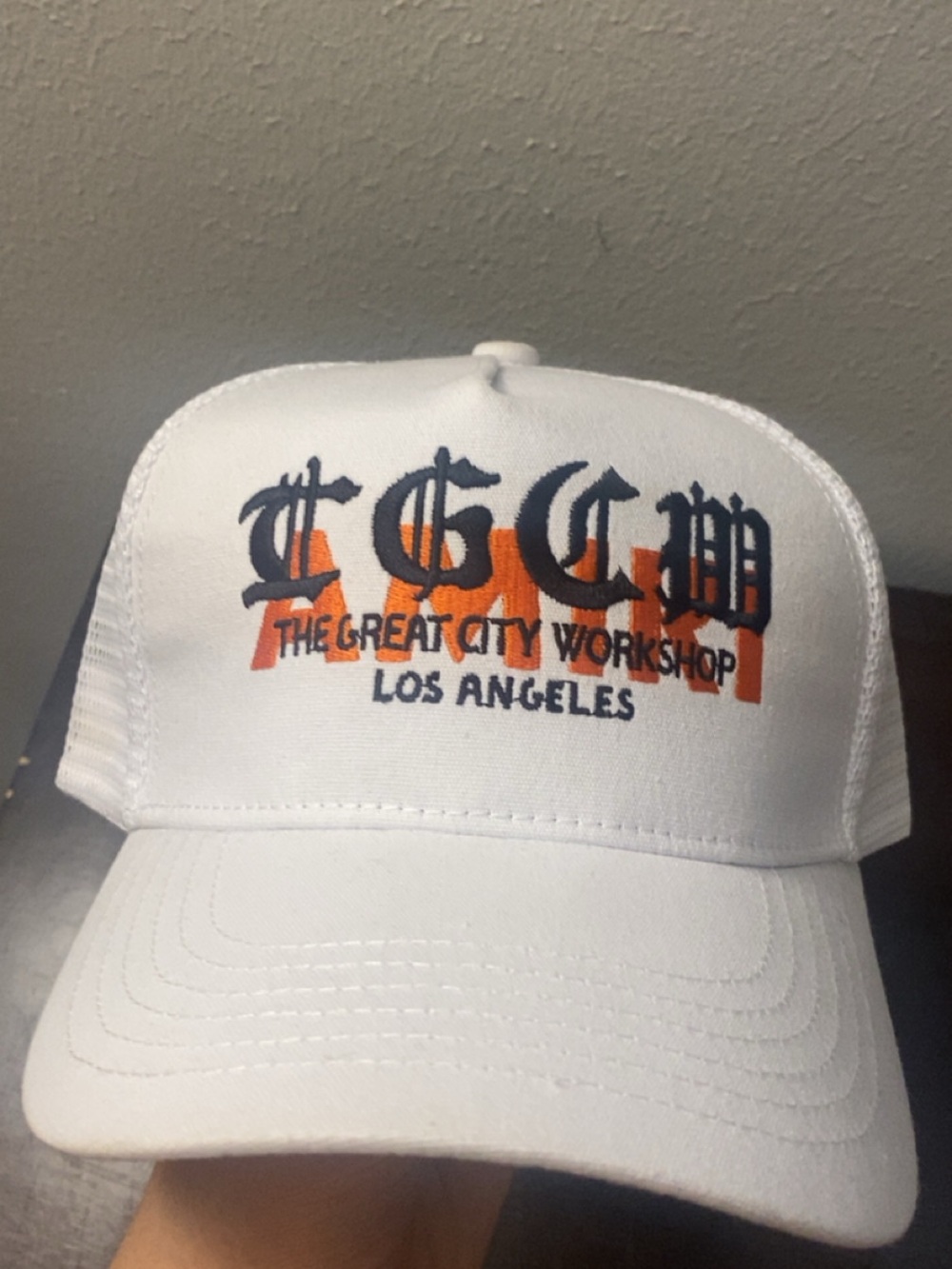 AMIRI White Trucker Hat with Navy & Orange Logo